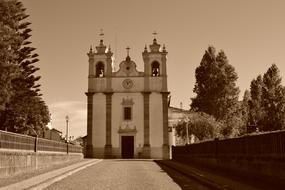 Retro photo of the beautiful church among the trees, in Montemor, Portugal