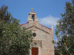 stone chapel among green trees