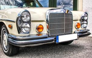 Beautiful, shiny, retro beige Daimler car with the sign