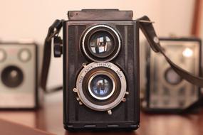 Beautiful, old camera on the wooden table