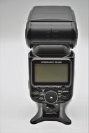 Close-up of the black hotshoe-mounted flash unit with the screen