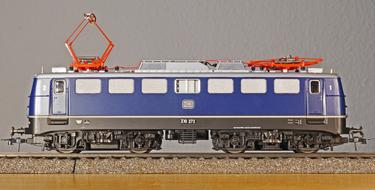 Blue, white, black and orange e10 train model on the railway