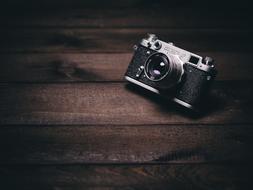 professional old camera on a wooden table