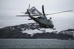 Helicopter above sea at snowy coast