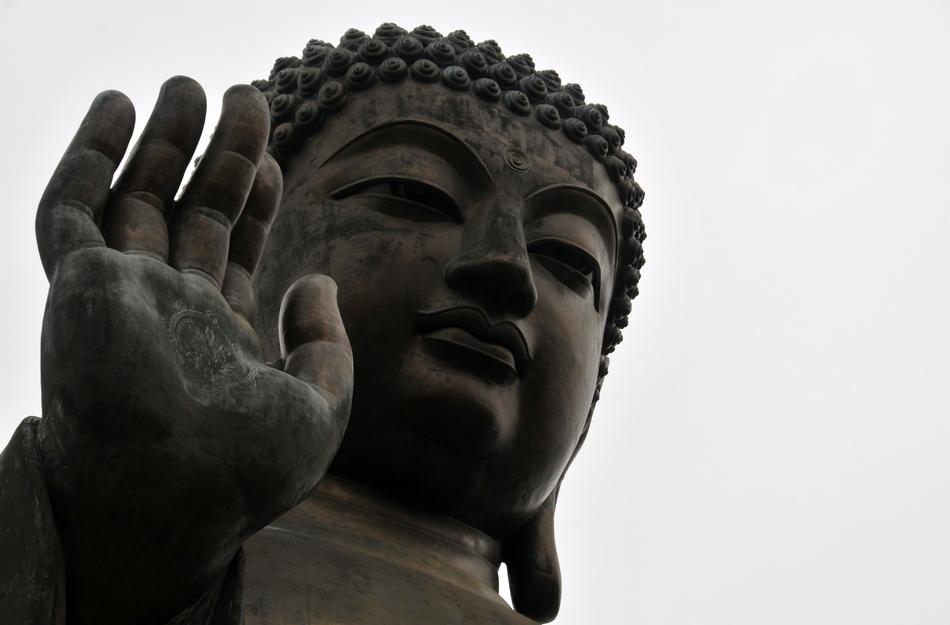 huge buddha statue with raised hand in asia