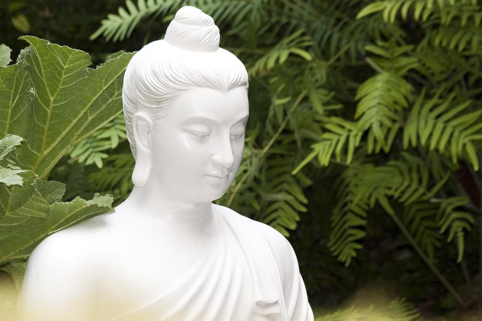 Buddha Sculpture white among the trees