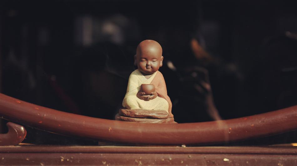 little buddha statue on blurred background