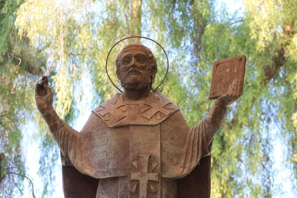 sculpture of St. nicholas in the park near the church