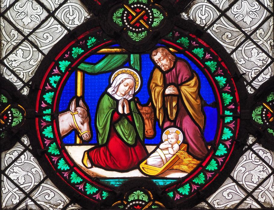 multicolored christmas plot on stained glass in church