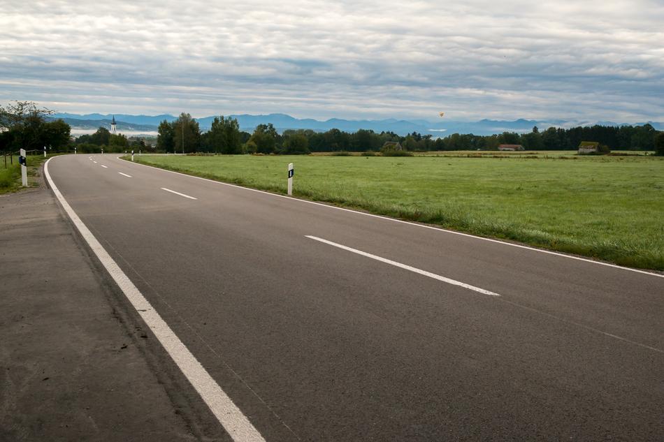 Road, among the beautiful green fields and trees in Diessen, Germany