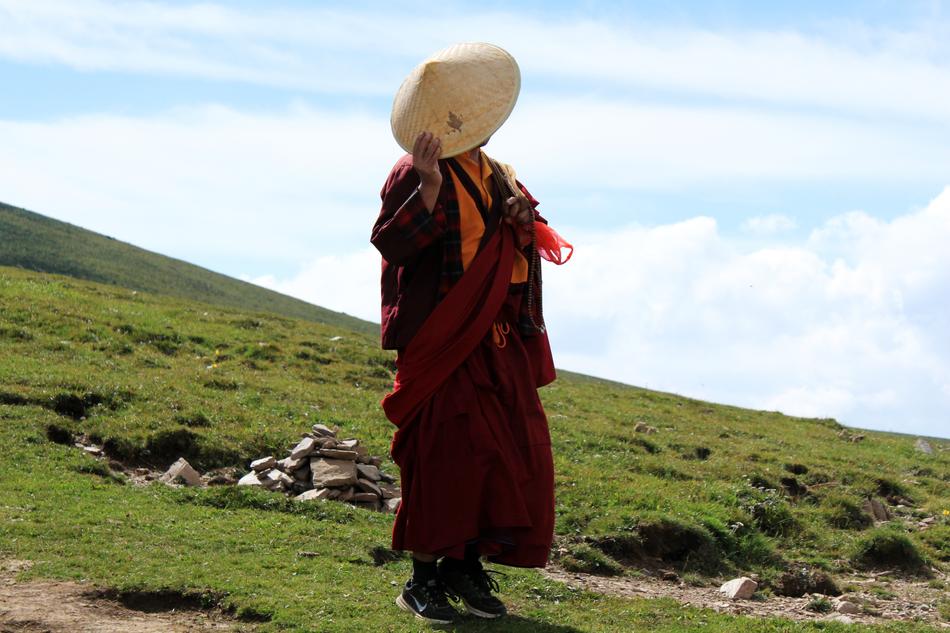 Man in hat, on the beautiful green mountain
