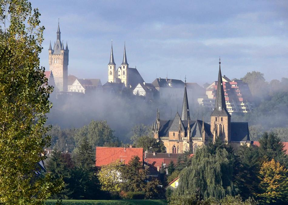 Beautiful and colorful landscape with the churches, among the colorful trees in Baden-Württemberg, Germany, in clouds