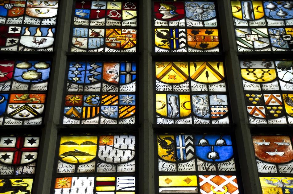 Beautiful and colorful, patterned stained glass windows of Oude Kerk in Amsterdam, Netherlands