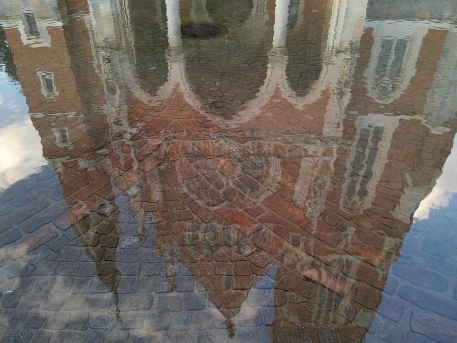 Reflection of an old church in a fountain in Graz, Austria