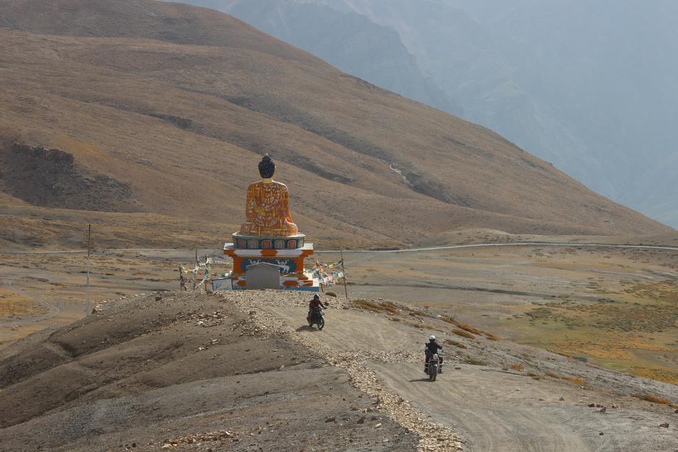 People, near the beautiful Buddha statue, among the mountains in Langza, Himachal, India