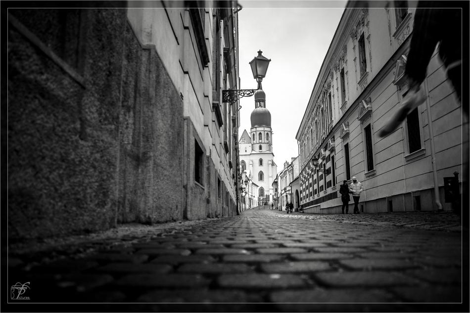 black and white photo of the street leading to the church
