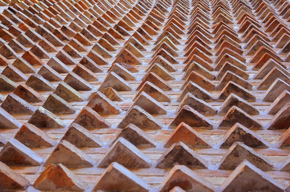 Close-up of the many, shiny bricks on the church, in light