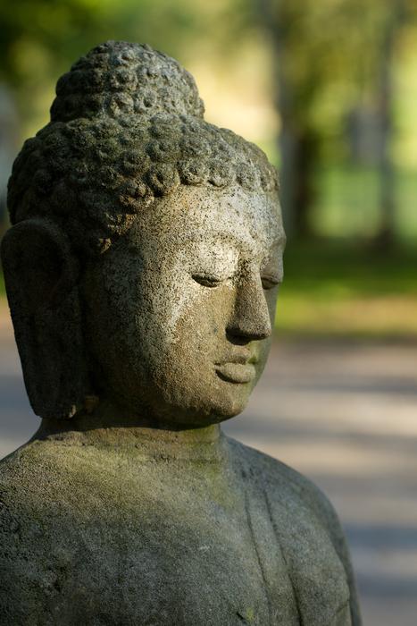 Stone Buddha Figure at sunlight