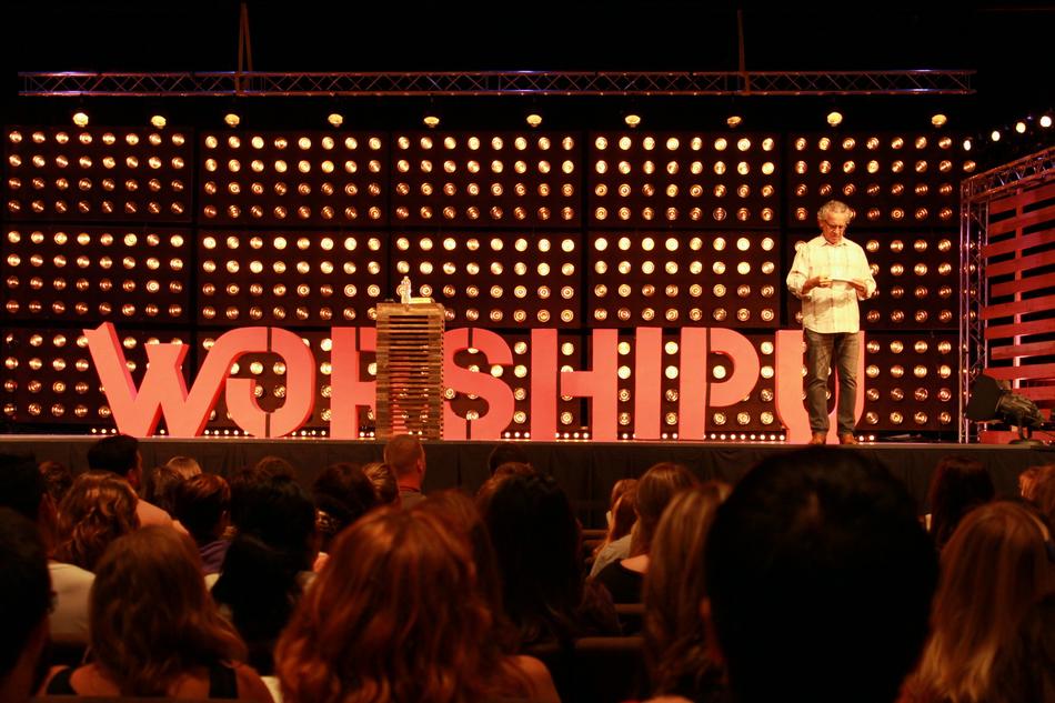 People and red 'Worship' sign in the Bethel Church, in California, USA