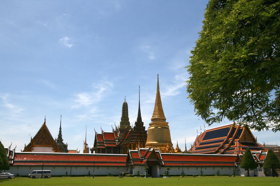 Beautiful and colorful temple, near the green lawn, with the trees, in the temple of Bangkok