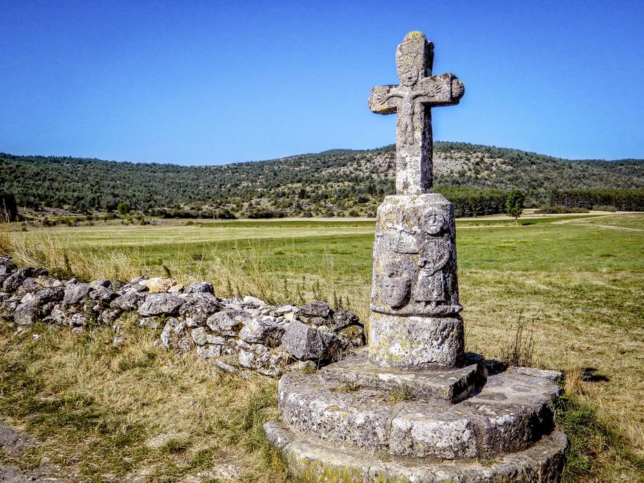 stone cross on the colorful and beautiful path on the hills