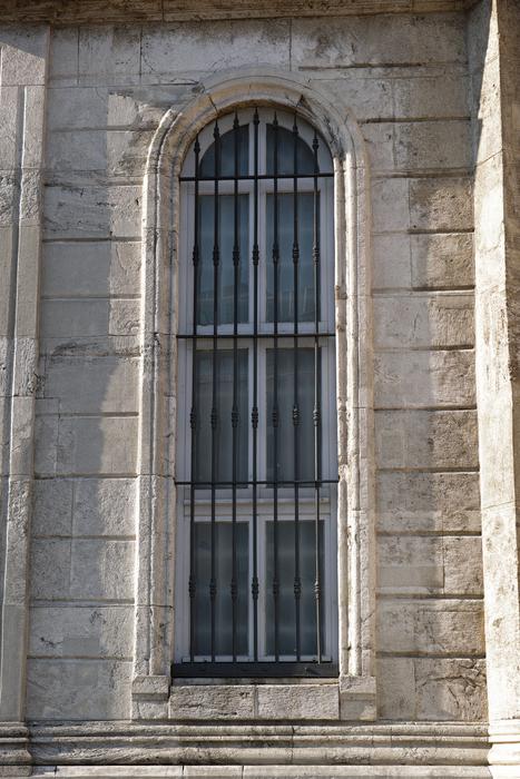 Window of the beautiful, old, stone church in sunlight