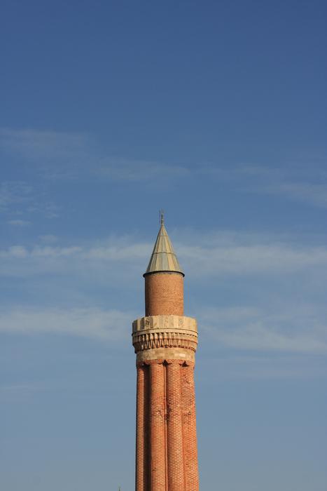 top of brick Minaret of Yivliminare Mosque at sky, turkey, anralya