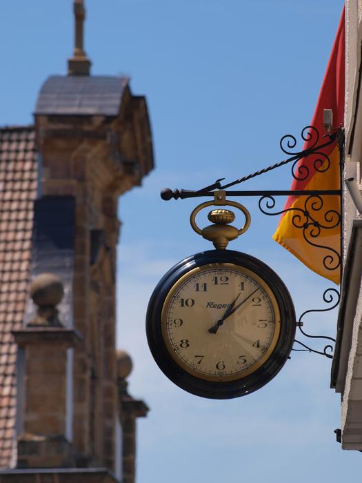 clock on the background of the church in the old town