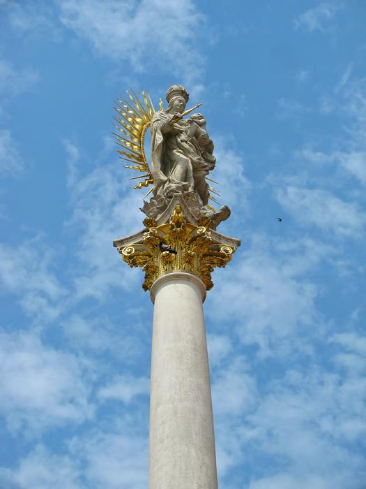 Madonna with a child on a white column