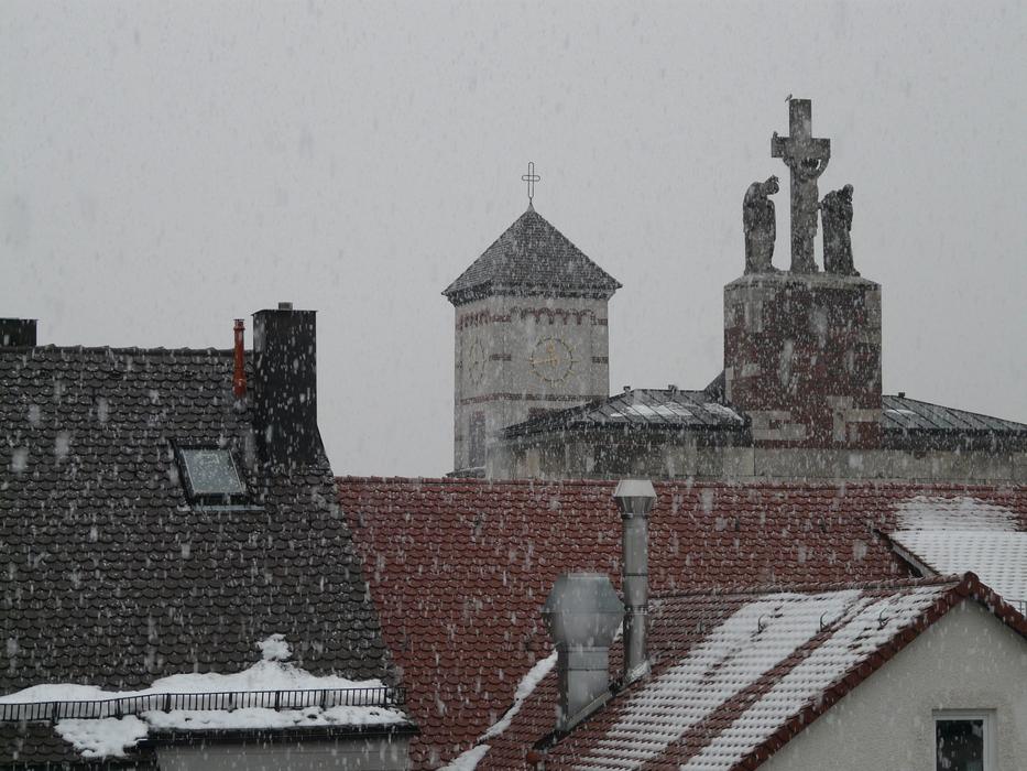 snowflakes fly over houses in winter