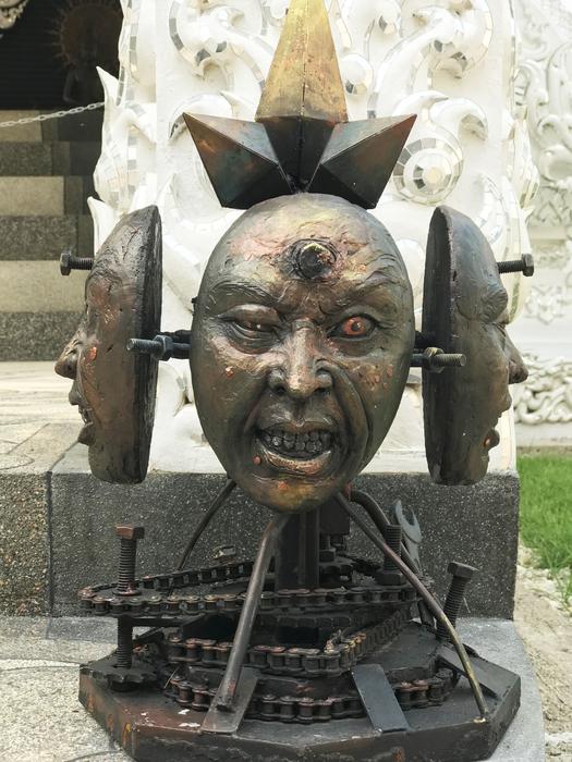 human masks with nails in foreheads, contemporary artwork, bronze