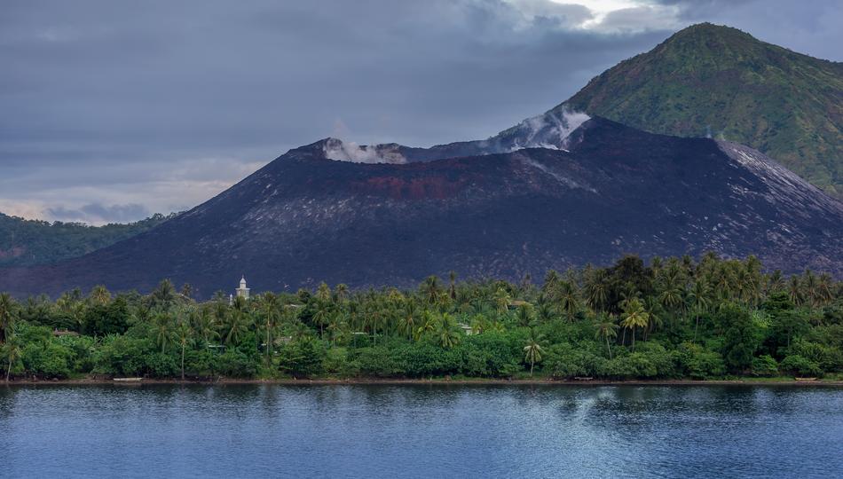 Beautiful landscape with volcano on the coast with green plants and church