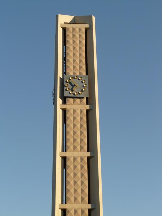 church clock on the tower against the blue sky