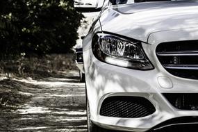 monochrome photo of the front of a white mercedes benz