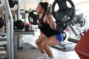 woman with a barbell in the gym