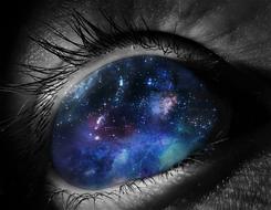 Close-up of the beautiful eye with colorful galaxy