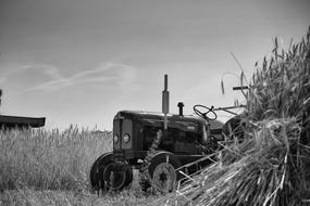 ancient tractor on the field in black and white background