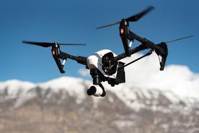 flying drone on a background of snowy mountains