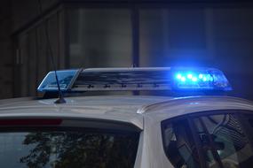 The blue light on a roof of Police Car