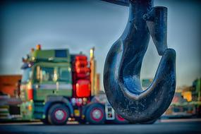 Close-up of a crane hook, near the colorful truck