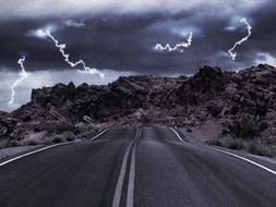 highway in Utah amid lightning and stormy sky