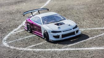 Beautiful, white and purple Mst Rc car, on the asphalt with white chalk traces