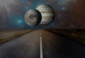 two planets over an asphalt road