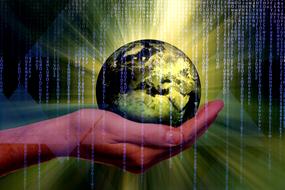planet on hand against the background of binary code