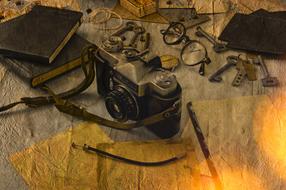 photomontage, old camera, glasses, keys and diaries