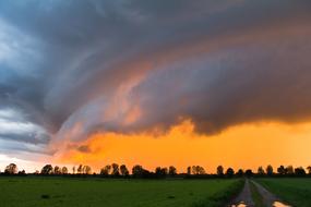 storm clouds over green fields