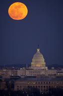 White House in Washington on a background of the yellow moon