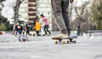 photo of teenager's legs on a skateboard