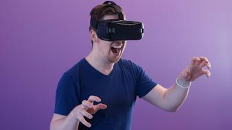 man with virtual reality glasses on a purple background