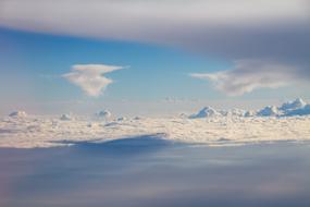 Beautiful view of the blue sky, with white clouds, from the plane